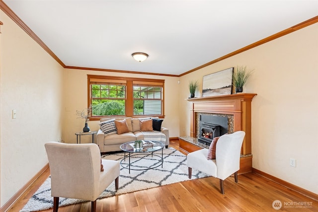 living room featuring wood finished floors, baseboards, and crown molding
