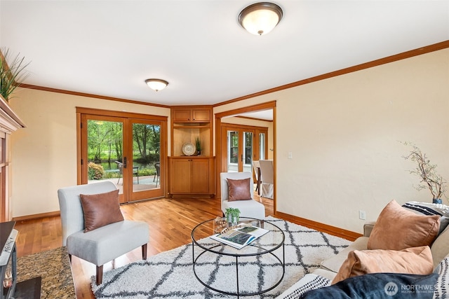 living room featuring french doors, ornamental molding, baseboards, and light wood-style floors