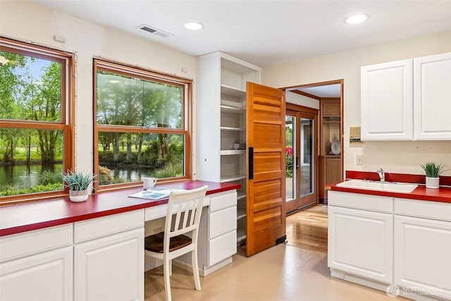 kitchen featuring a sink, white cabinetry, and recessed lighting