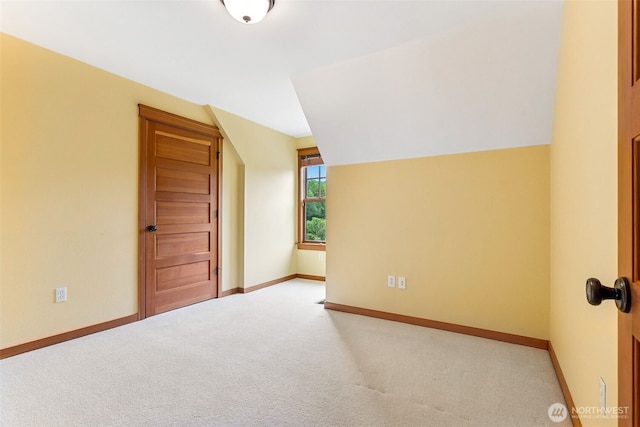 bonus room featuring carpet, lofted ceiling, and baseboards