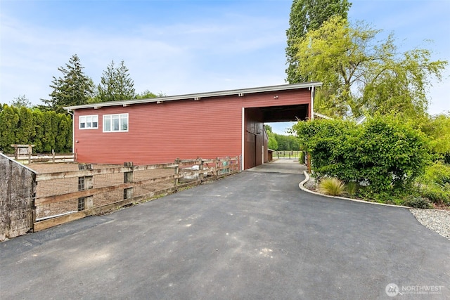 view of side of home featuring an outdoor structure