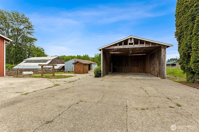 garage with a carport and driveway