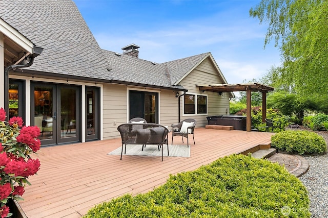 wooden terrace featuring a hot tub, an outdoor hangout area, and a pergola