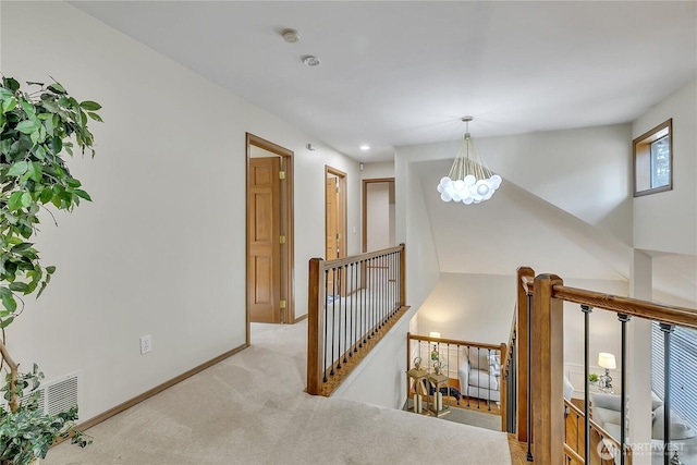8612 165th Street Ct E, Puyallup, WA 98375 - hallway featuring an upstairs landing, light carpet, a chandelier, and baseboards