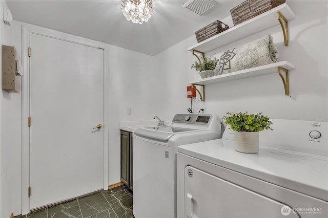 8612 165th Street Ct E, Puyallup, WA 98375 - clothes washing area featuring dark marble finish floors, washing machine and dryer, and cabinet space