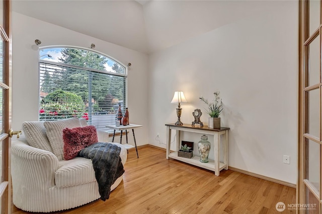 8612 165th Street Ct E, Puyallup, WA 98375 - living area featuring light wood-style floors, vaulted ceiling, and baseboards