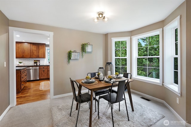 6423 138th Pl SE, Snohomish, WA 98296 - dining space with light carpet, baseboards, and plenty of natural light