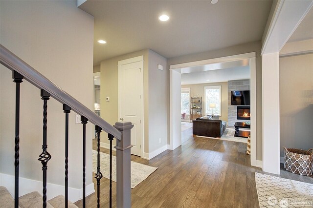 7223 NE 118th Ct, Kirkland, WA 98034 - foyer with stairway, wood finished floors, baseboards, a large fireplace, and recessed lighting