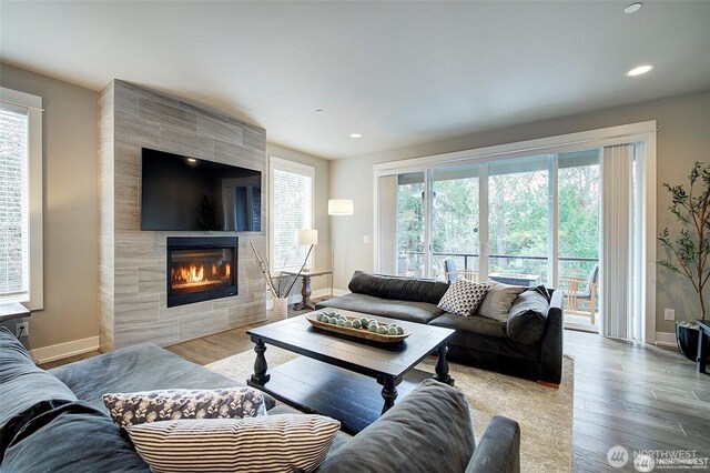 7223 NE 118th Ct, Kirkland, WA 98034 - living room featuring wood finished floors, a tiled fireplace, baseboards, and recessed lighting