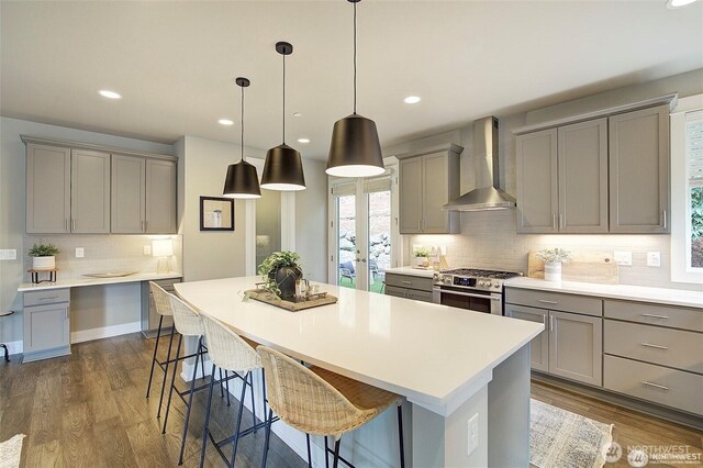 7223 NE 118th Ct, Kirkland, WA 98034 - kitchen with wall chimney exhaust hood, gray cabinets, gas range, decorative backsplash, and recessed lighting