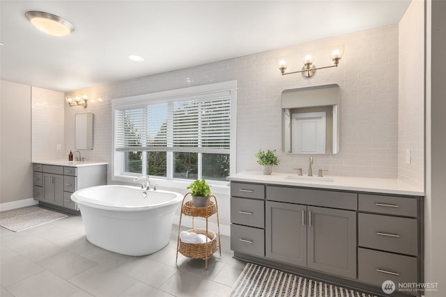 7223 NE 118th Ct, Kirkland, WA 98034 - full bath featuring two vanities, a freestanding bath, tile patterned flooring, and backsplash