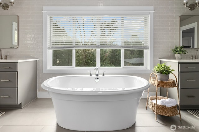 7223 NE 118th Ct, Kirkland, WA 98034 - full bathroom featuring healthy amount of natural light, a soaking tub, vanity, tile walls, and tile patterned floors