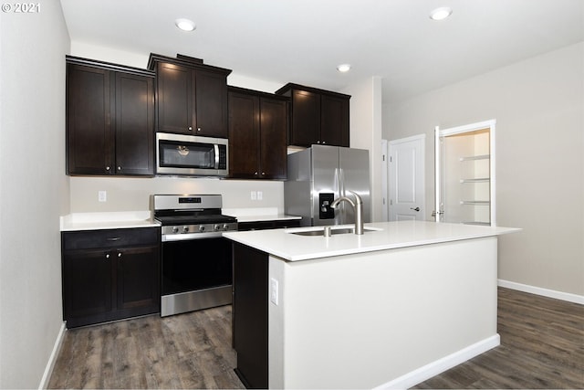 15326 NE 70th St, Vancouver, WA 98682 - kitchen with stainless steel appliances, a sink, dark wood-type flooring, a center island with sink, and baseboards