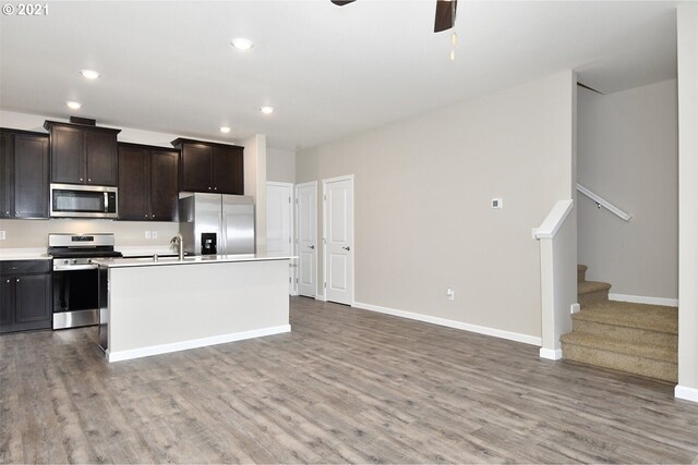 15326 NE 70th St, Vancouver, WA 98682 - kitchen featuring appliances with stainless steel finishes, wood finished floors, a ceiling fan, a kitchen island with sink, and recessed lighting