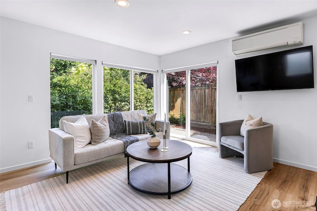 4757 Delridge Way SW, Seattle, WA 98106 - living room featuring a wall mounted AC, plenty of natural light, light wood-style flooring, and recessed lighting