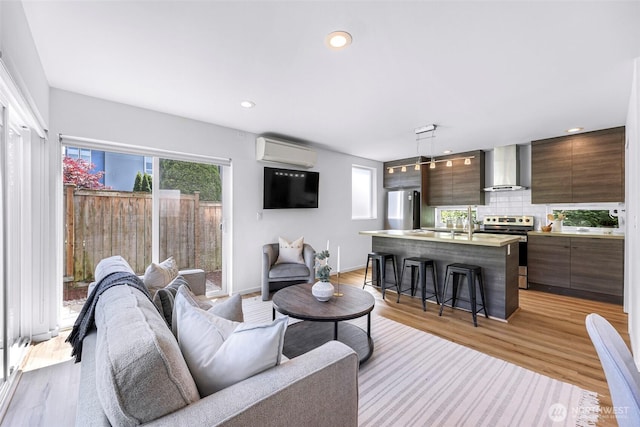 4757 Delridge Way SW, Seattle, WA 98106 - living area with a wall mounted air conditioner, light wood-style flooring, and recessed lighting