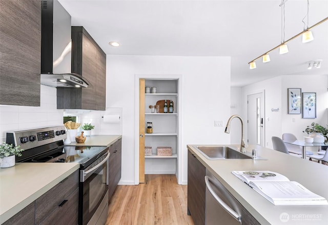 4757 Delridge Way SW, Seattle, WA 98106 - kitchen with appliances with stainless steel finishes, wall chimney exhaust hood, a sink, light countertops, and modern cabinets