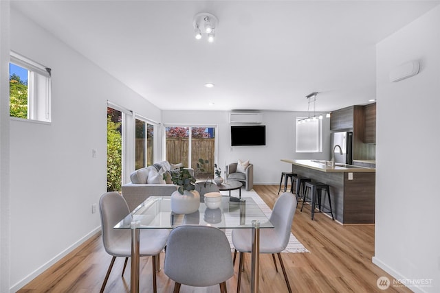 4757 Delridge Way SW, Seattle, WA 98106 - dining area featuring baseboards, light wood-style floors, a wall mounted air conditioner, and recessed lighting