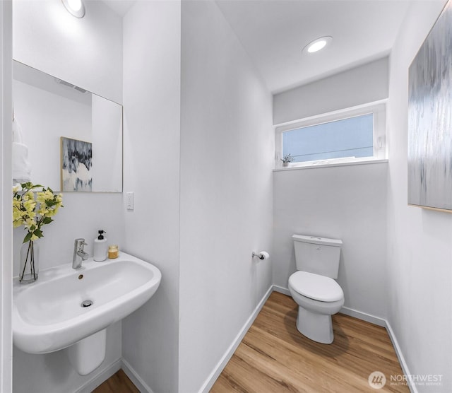 4757 Delridge Way SW, Seattle, WA 98106 - bathroom with toilet, wood finished floors, a sink, and baseboards