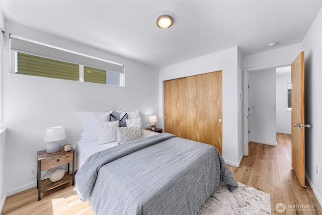 4757 Delridge Way SW, Seattle, WA 98106 - bedroom featuring a closet, light wood finished floors, and baseboards