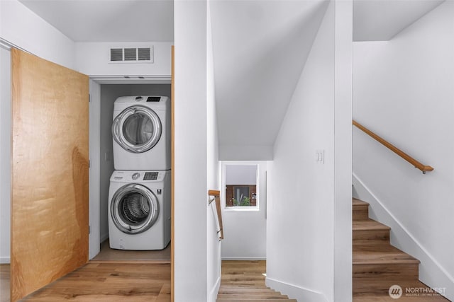 4757 Delridge Way SW, Seattle, WA 98106 - washroom featuring stacked washer / drying machine and wood finished floors