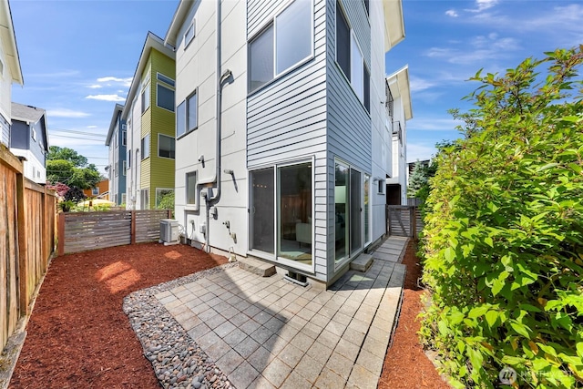 4757 Delridge Way SW, Seattle, WA 98106 - back of house with central AC unit, a fenced backyard, and a patio