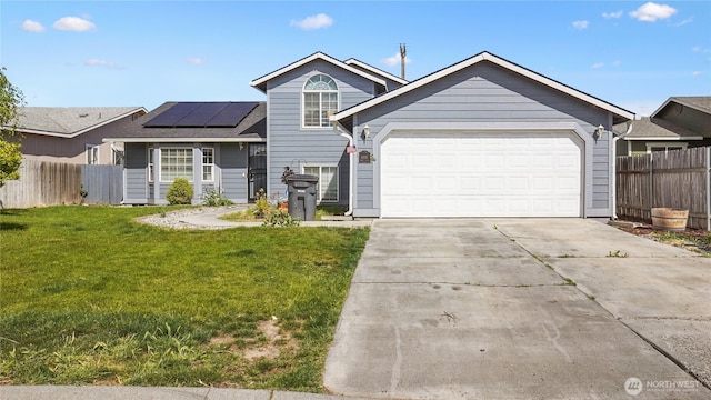 1115 S Rose Pl, Othello, WA 99344 - view of front facade with roof mounted solar panels, concrete driveway, and a garage