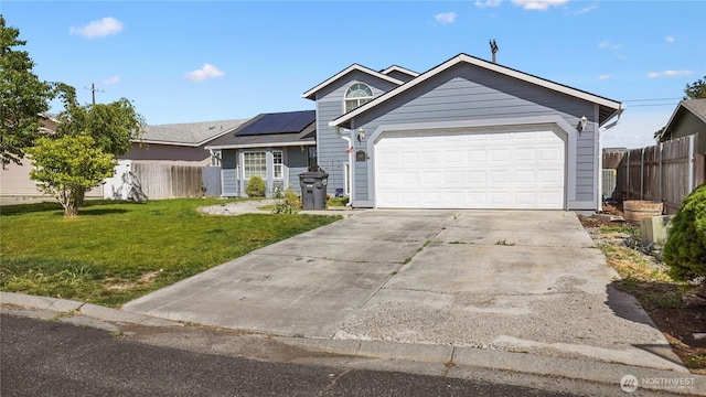 1115 S Rose Pl, Othello, WA 99344 - view of front of house featuring solar panels, driveway, and a garage
