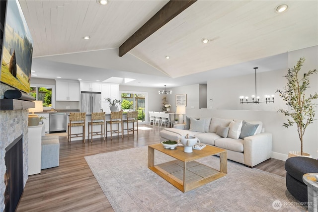 17905 NE 19th Pl, Bellevue, WA 98008 - living area with a chandelier, light wood finished floors, recessed lighting, a large fireplace, and baseboards