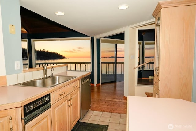 585 Raccoon Point Rd, Orcas Island, WA 98245 - kitchen with light brown cabinetry, a sink, light tile patterned floors, stainless steel dishwasher, and light countertops