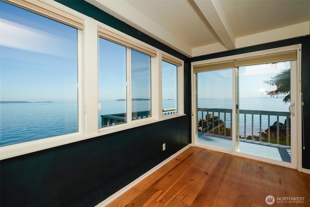 585 Raccoon Point Rd, Orcas Island, WA 98245 - unfurnished sunroom featuring a water view, baseboards, wood-type flooring, and beam ceiling