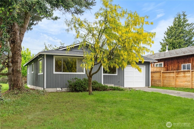 view of front of property featuring concrete driveway and an attached garage