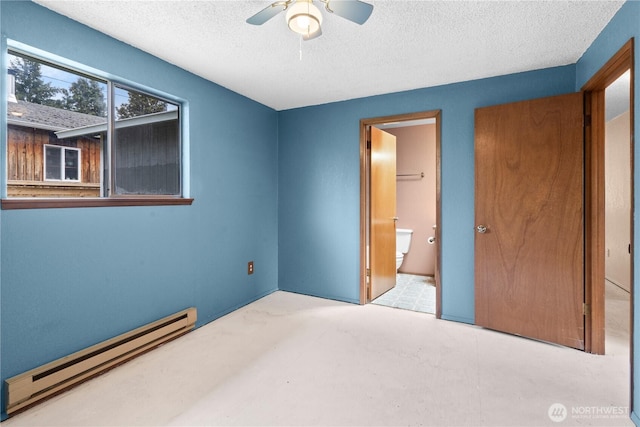 unfurnished bedroom featuring a baseboard heating unit, a textured ceiling, ensuite bath, and ceiling fan