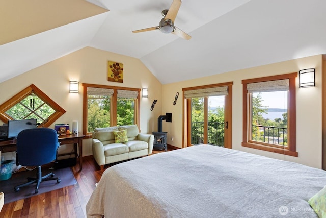 1433 Madison St, Port Townsend, WA 98368 - bedroom with a wood stove, wood finished floors, vaulted ceiling, a ceiling fan, and an office area