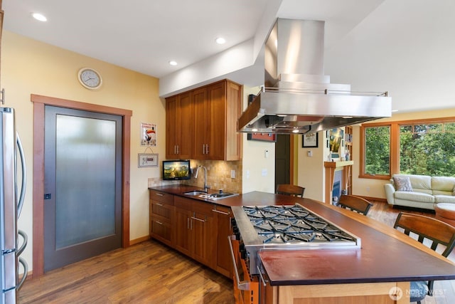 1433 Madison St, Port Townsend, WA 98368 - kitchen with island range hood, a sink, a peninsula, dark countertops, and recessed lighting