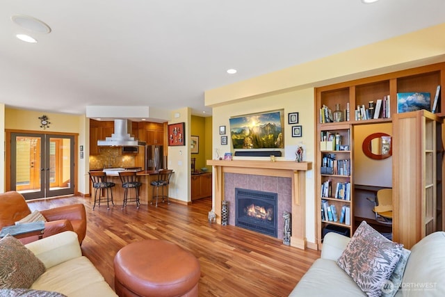 1433 Madison St, Port Townsend, WA 98368 - living area with wood finished floors, french doors, a tiled fireplace, and recessed lighting