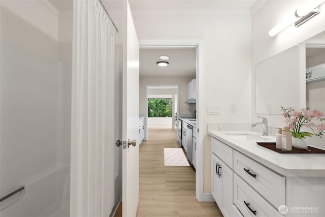 18771 Harris Ave NE, Suquamish, WA 98392 - bathroom with wood finished floors, vanity, and ornamental molding