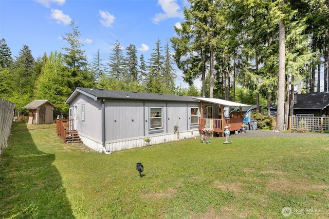 300 E Skookum Dr NE, Shelton, WA 98584 - back of property featuring a storage unit, an outdoor structure, and a deck