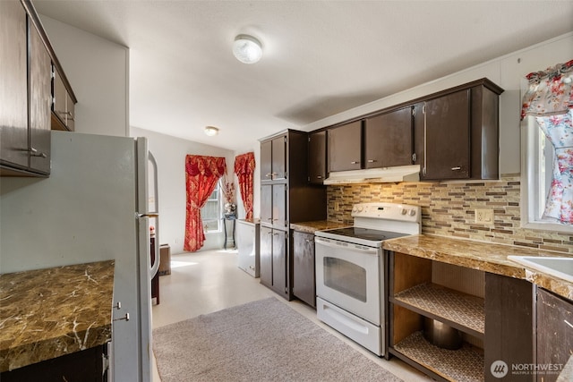 300 E Skookum Dr NE, Shelton, WA 98584 - kitchen with white appliances, under cabinet range hood, decorative backsplash, dark brown cabinetry, and vaulted ceiling