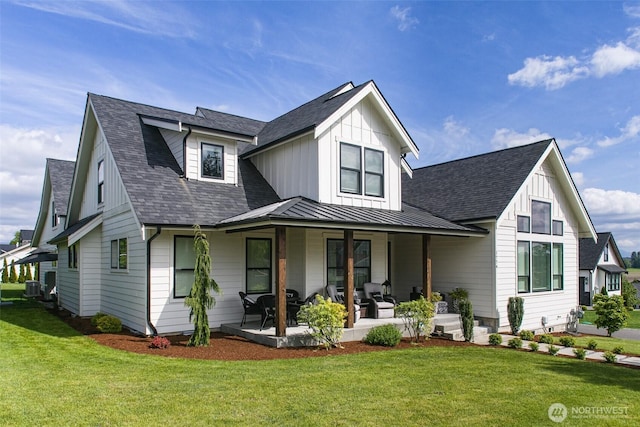 1774 Farmview Ter, Lynden, WA 98264 - modern inspired farmhouse featuring a front lawn, a standing seam roof, metal roof, central AC unit, and a shingled roof