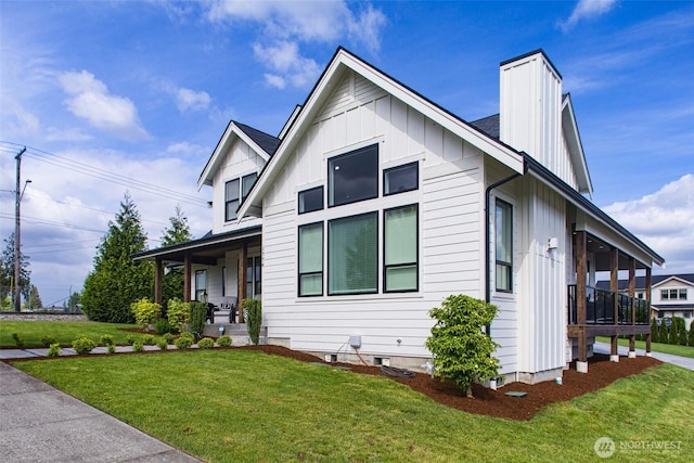 1774 Farmview Ter, Lynden, WA 98264 - view of front of home with board and batten siding, a porch, a front yard, and a chimney