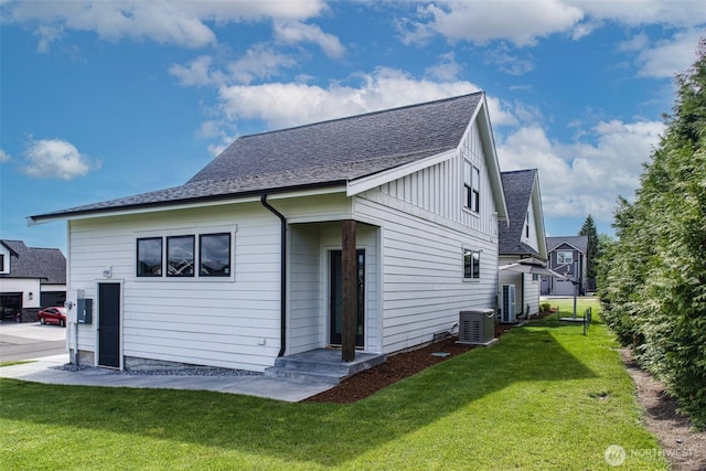 1774 Farmview Ter, Lynden, WA 98264 - back of property with cooling unit, a shingled roof, a yard, and board and batten siding