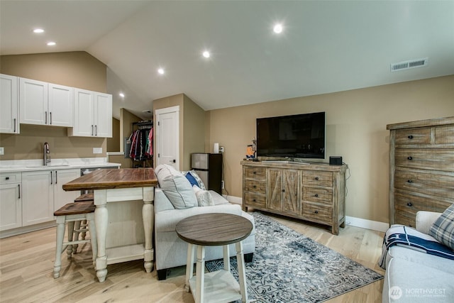 1774 Farmview Ter, Lynden, WA 98264 - living room featuring light wood-style floors, lofted ceiling, recessed lighting, and baseboards
