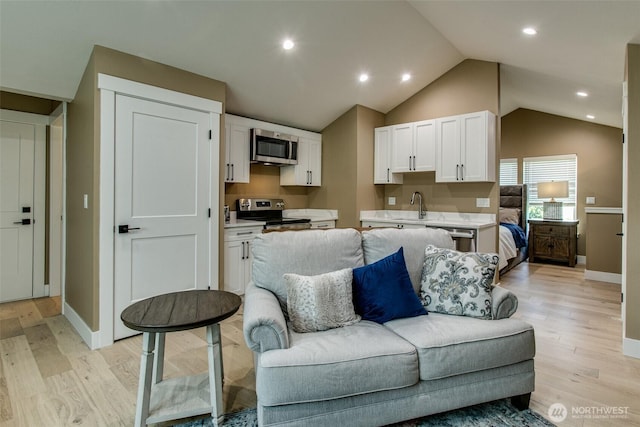1774 Farmview Ter, Lynden, WA 98264 - living area featuring lofted ceiling, light wood-style floors, baseboards, and recessed lighting