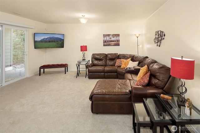 carpeted living room with baseboards