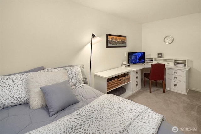 bedroom featuring baseboards, light carpet, and an office area