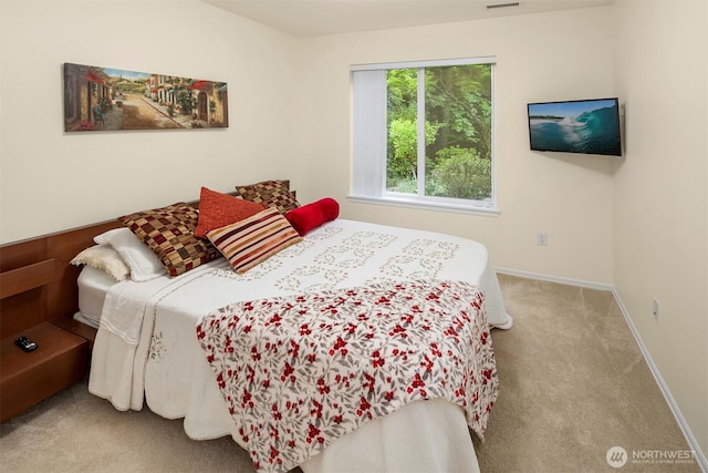 carpeted bedroom featuring baseboards