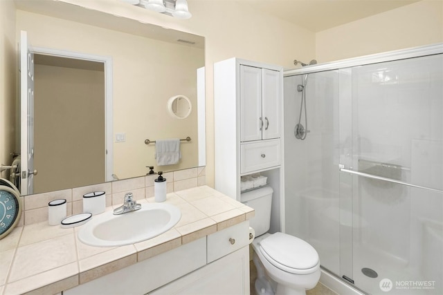 full bathroom with a shower stall, backsplash, toilet, and vanity