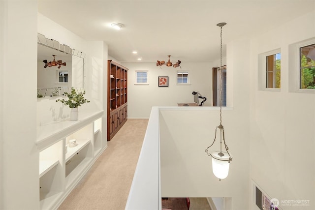 corridor with carpet flooring, a sink, and recessed lighting