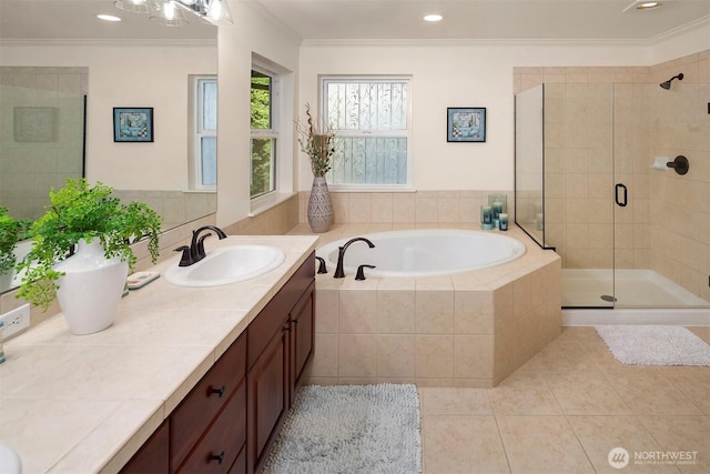 bathroom featuring ornamental molding, a shower stall, tile patterned flooring, a bath, and vanity